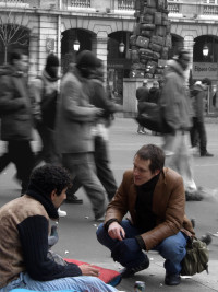 egy férfi beszélget egy hajléktalannal